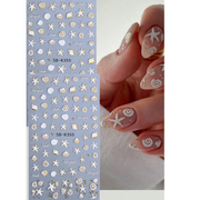 מדבקות ציפורניים 5D בצבע לבן וזהב | דפי צדפים וכוכבי ים | 2 יחידות